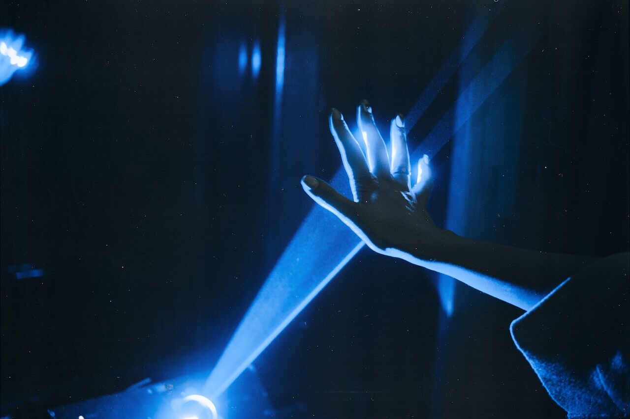 Blue Light moving through a human hand